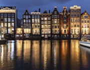 Dancing Houses Damrak Amsterdam during the evening lights Netherlands.
