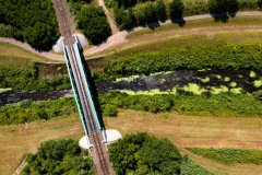 Railway line over the brook with bridge. Aerial railway line and green area