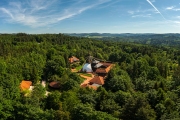 Aerial photo about Nepal Tibet pavilion in Germany. Spiritual temple tower with hanging flags. Time for meditation and thoughts in the Nepal Himalaya.