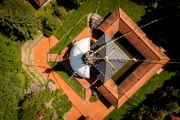 Aerial photo about Nepal Tibet pavilion in Germany. Spiritual temple tower with hanging flags. Time for meditation and thoughts in the Nepal Himalaya.
