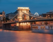 Blue hour in Budapest with Chain bridge. Including Danube river and Gresham palace. St Stephen basilica appear in the background.