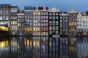 Dancing Houses Damrak Amsterdam during the evening lights Netherlands.