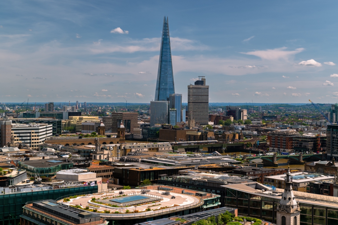 Panoramic aerial city scape about London city with skyscapers. Amazing sunny day with a bit cloudy sky.