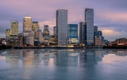 Canary wharf cityscape. The buildings are reflected in Thames river’s water. Canary wharf is the business districet in London City UK.