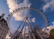 The Coca-cola London eye with perspective. Fantastic view, colorful autumn trees and blue sky with clouds.