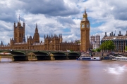Amazing London cityscape what is included the Big Ben, Goverment's parliament. Westminster abbey's towers is on the background. Thames river and westminster bridge. With tipical english cloudy sky.
