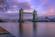 Lonfon bridge reflected in thames river with clouds. Amazing moring lights, colorful clouds.