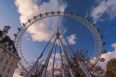 The Coca-cola London eye with perspective. Fantastic view, colorful autumn trees and blue sky with clouds.