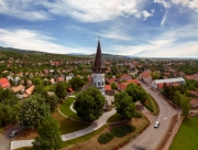 Aerial photo about the Church of the Assumption in Gyongyospata Hungary. Historical religious monument. Built in 12th century romanian baroque and gothic style. popular tourist attraction.