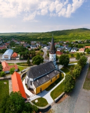 Aerial photo about the Church of the Assumption in Gyongyospata Hungary. Historical religious monument. Built in 12th century romanian baroque and gothic style. popular tourist attraction.