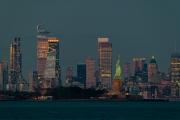 Cityscape landscape in blue hour about New York. included the Statue of liberty. Lady liberty is on the middle New York Skyscrapers is on the background included the famous Edge observation deck too