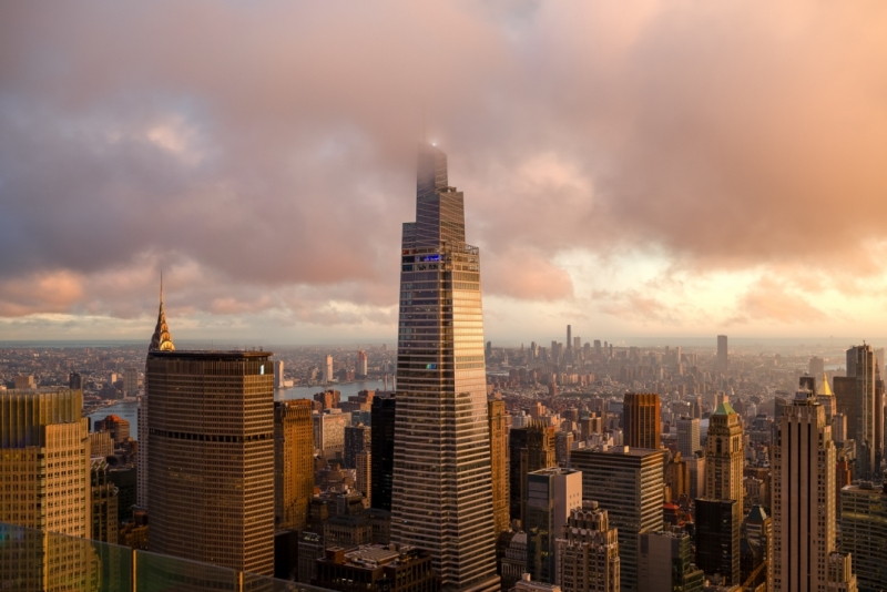 Epic sunset after the rain. Amazing aerial cityscape landscape about New York city, Manhattan. Famous skyscrapers on the photo. Cloud covered high lines.