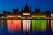 The Hungarian parliament luminous with the national colors.