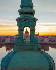 Unique photo about the Hungarian Parliament building through a church belltower. Amazing morning mood.