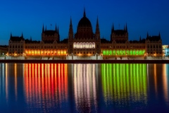 The Hungarian parliament luminous with the national colors.
