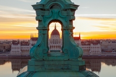 Unique photo about the Hungarian Parliament building through a church belltower. Amazing morning mood.