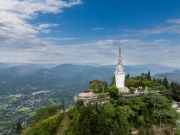 Ambuluwawa Tower in Gampola, Sri Lanka, stands tall atop a lush mountain, offering panoramic views and a unique spiral design symbolizing cultural and religious harmony