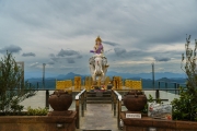 A majestic statue of Samantabhadra Bodhisattva riding a white elephant at Nelligala International Buddhist Centre, Sri Lanka, set against a panoramic mountain view.