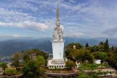 Ambuluwawa Tower in Gampola, Sri Lanka, stands tall atop a lush mountain, offering panoramic views and a unique spiral design symbolizing cultural and religious harmony