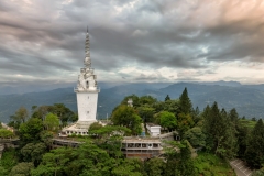Ambuluwawa Tower in Gampola, Sri Lanka, stands tall atop a lush mountain, offering panoramic views and a unique spiral design symbolizing cultural and religious harmony