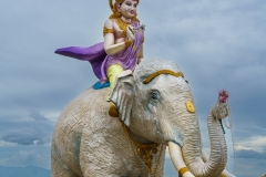 A majestic statue of Samantabhadra Bodhisattva riding a white elephant at Nelligala International Buddhist Centre, Sri Lanka, set against a panoramic mountain view.