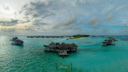 Famous overwater bungalows villas in the Maldives Islands. Crystal clear water in the Indian Ocean. Amazing lagoons with sandy beaches.