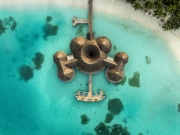 Famous overwater bungalows villas in the Maldives Islands. Crystal clear water in the Indian Ocean. Amazing lagoons with sandy beaches.