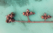 Famous overwater bungalows villas in the Maldives Islands. Crystal clear water in the Indian Ocean. Amazing lagoons with sandy beaches.
