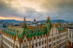Amazing roof in Budapest, Hungary. State Treasury building with Hungarian Parliament in winter time.  All tiles on the roof made from the world famous Zsolnay pyro granite.