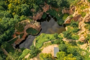 Flooded ancient stone quarry in Hungary near Sarospatak. Megyer-hegyi tengerszem. Small lake at the top of a hill. View from the top. Fantastic nature attraction in Tokaj area.