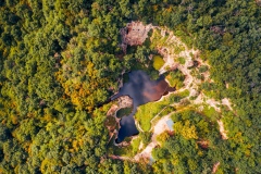 Flooded ancient stone quarry in Hungary near Sarospatak. Megyer-hegyi tengerszem. Small lake at the top of a hill. View from the top. Fantastic nature attraction in Tokaj area.